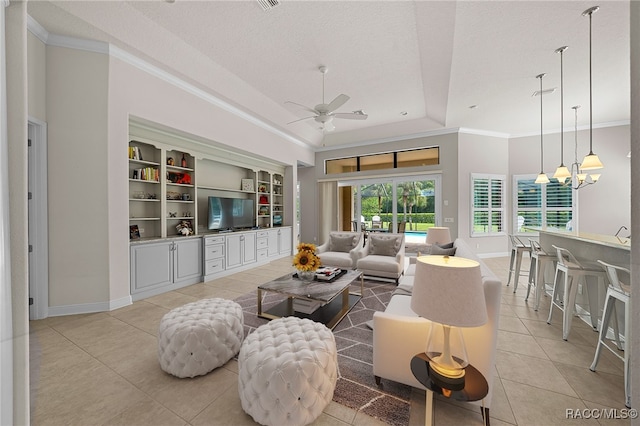 living room featuring crown molding, light tile patterned floors, ceiling fan with notable chandelier, and a textured ceiling