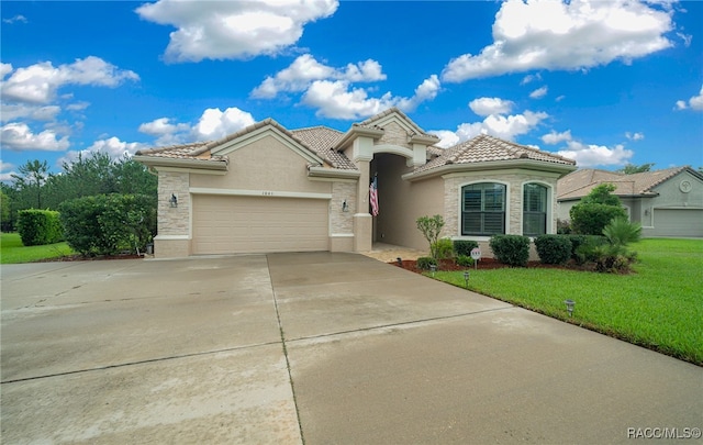 mediterranean / spanish-style house with a front yard and a garage