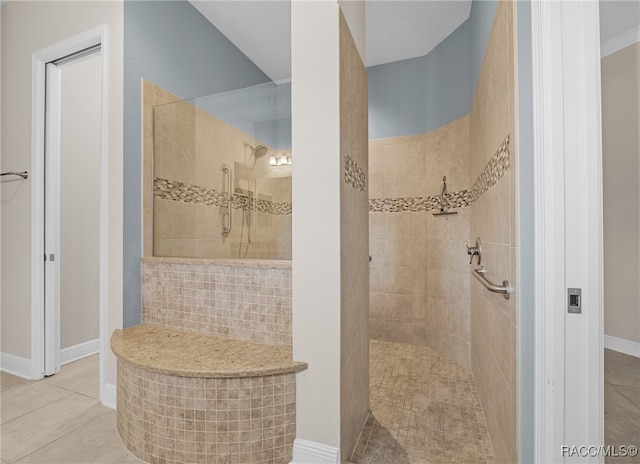 bathroom with tile patterned flooring, baseboards, and walk in shower