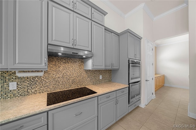 kitchen with backsplash, ornamental molding, stainless steel double oven, light tile patterned floors, and gray cabinets