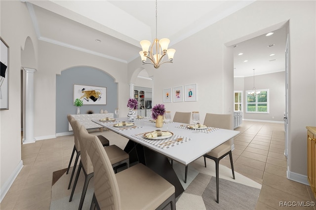 dining room with decorative columns, arched walkways, light tile patterned floors, and a chandelier