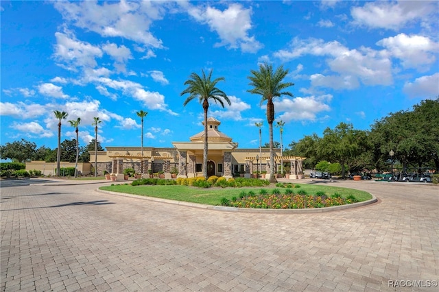 view of building exterior with curved driveway