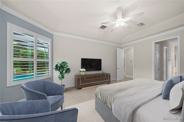 bedroom with ceiling fan, a raised ceiling, and ornamental molding