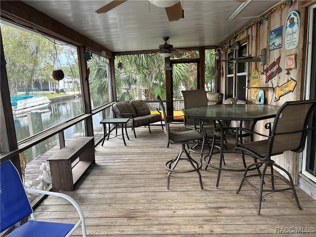 sunroom / solarium with plenty of natural light and ceiling fan