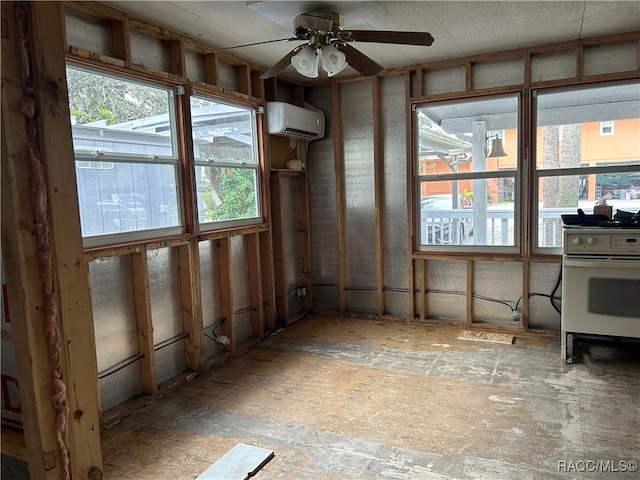 miscellaneous room with plenty of natural light, an AC wall unit, and ceiling fan