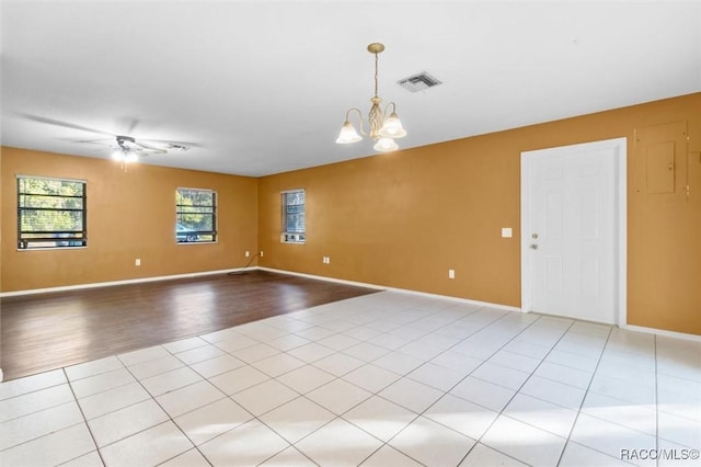 9780 W Tennessee Ln, Crystal River, FL 34428 - unfurnished room with light tile patterned floors and ceiling fan with notable chandelier