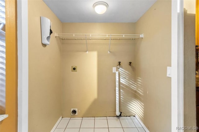 9780 W Tennessee Ln, Crystal River, FL 34428 - laundry room with electric dryer hookup, hookup for a washing machine, and light tile patterned floors