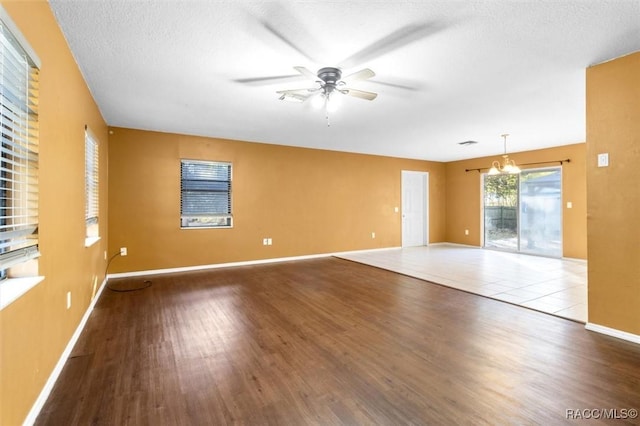 9780 W Tennessee Ln, Crystal River, FL 34428 - unfurnished room featuring hardwood / wood-style floors, ceiling fan with notable chandelier, and a textured ceiling
