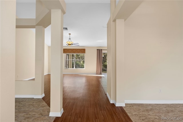 hallway with hardwood / wood-style flooring