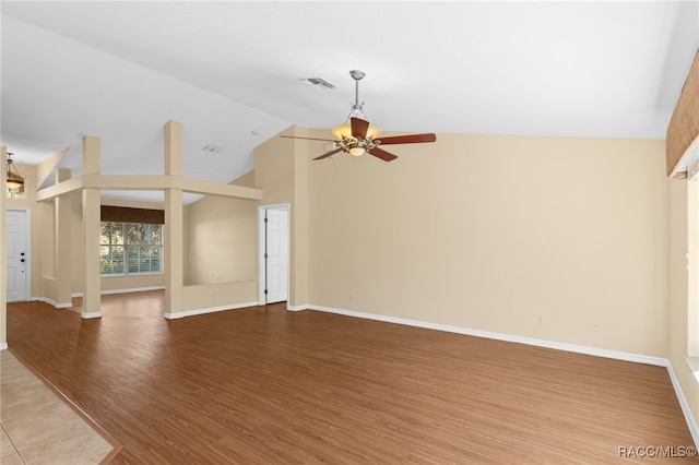 unfurnished living room featuring hardwood / wood-style floors, high vaulted ceiling, and ceiling fan