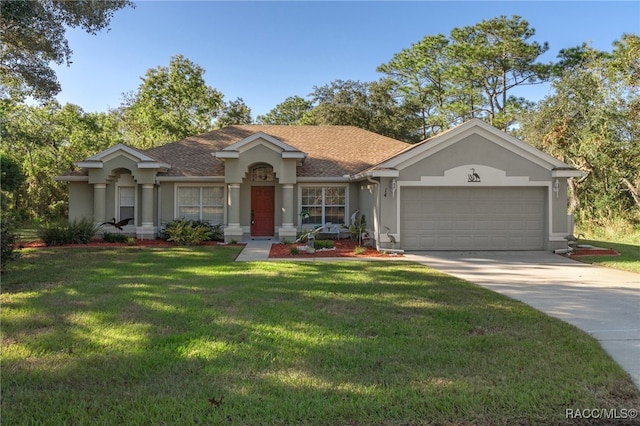 ranch-style house featuring a front lawn and a garage