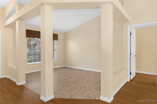 interior space featuring hardwood / wood-style floors and lofted ceiling