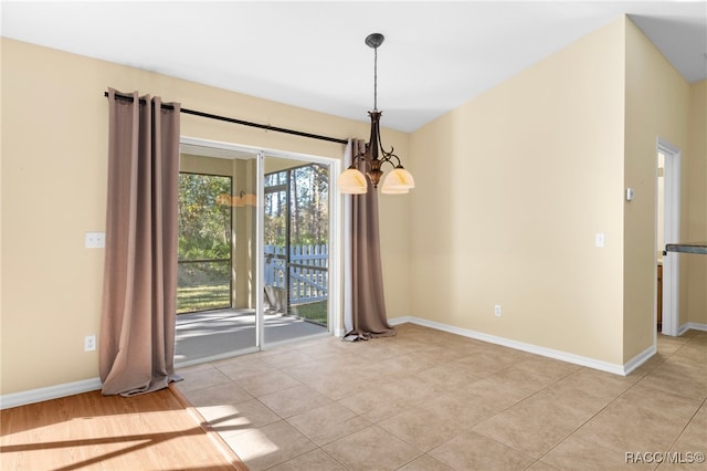 unfurnished dining area featuring light tile patterned floors and a chandelier