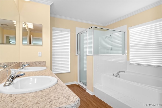 bathroom with a healthy amount of sunlight, wood-type flooring, and ornamental molding