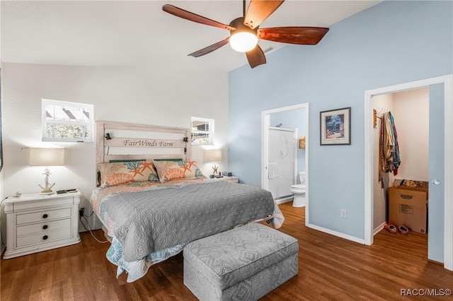 bedroom featuring lofted ceiling, dark hardwood / wood-style floors, ceiling fan, connected bathroom, and a closet