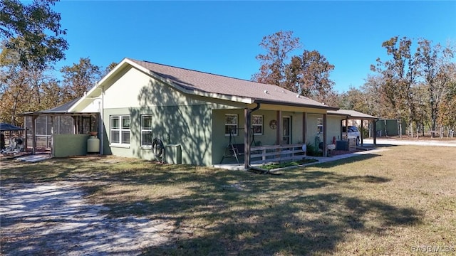 exterior space featuring a lawn and a sunroom