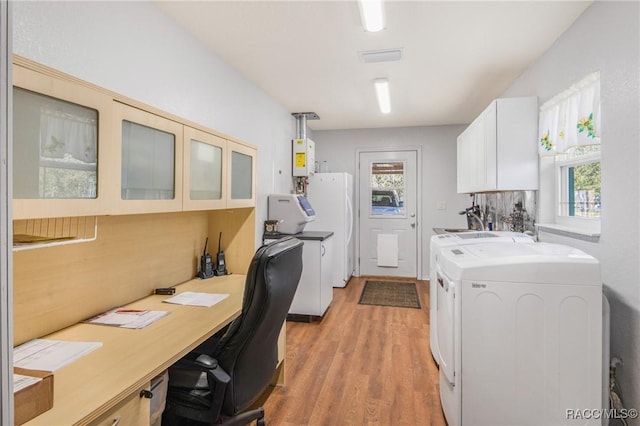 interior space with white cabinets, a healthy amount of sunlight, light wood-type flooring, and pendant lighting