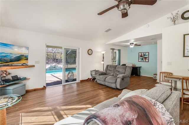 living room with wood-type flooring, ceiling fan, and lofted ceiling