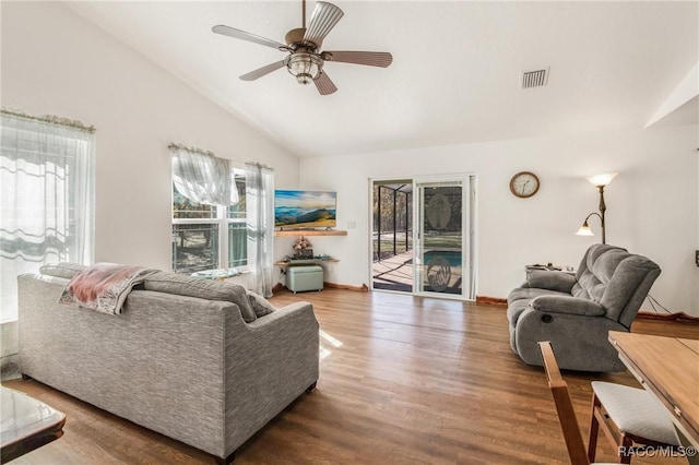 living room featuring hardwood / wood-style flooring, ceiling fan, and vaulted ceiling