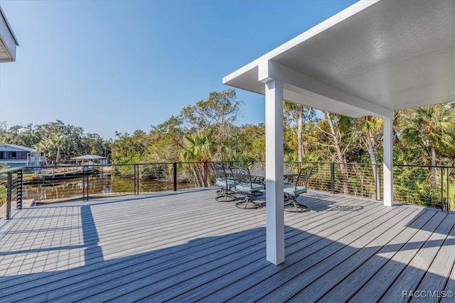 wooden terrace featuring outdoor dining space
