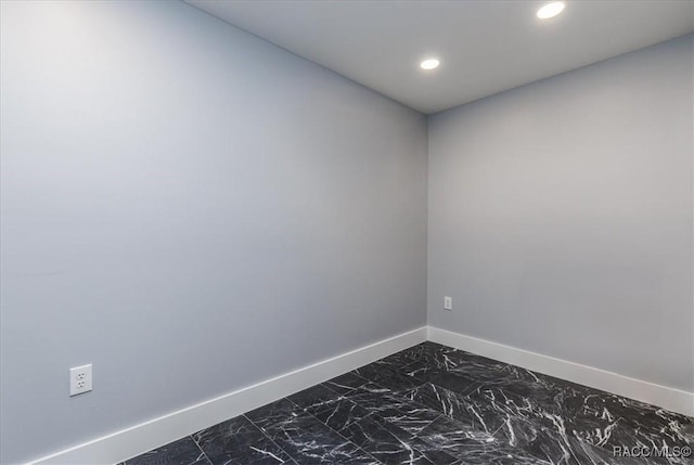spare room featuring baseboards, marble finish floor, and recessed lighting