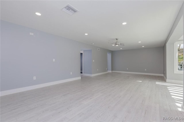 spare room featuring ceiling fan and light hardwood / wood-style floors