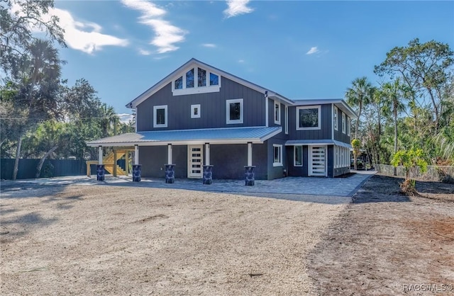 view of front of home with fence and metal roof
