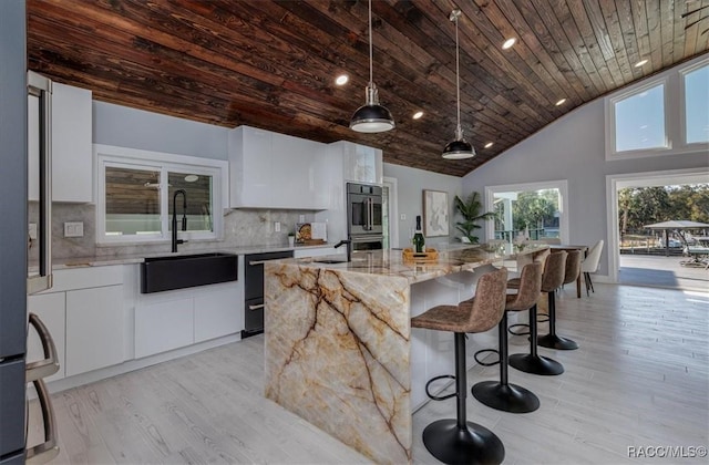 kitchen with white cabinets, dishwasher, a sink, modern cabinets, and wood ceiling