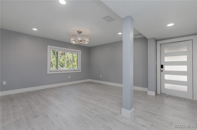 foyer featuring light hardwood / wood-style floors and a chandelier