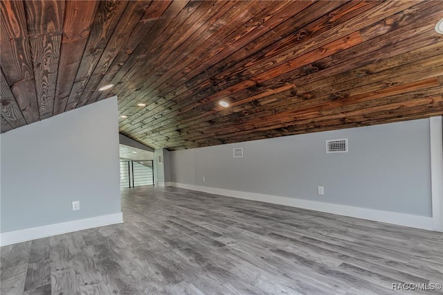 additional living space with vaulted ceiling, wood finished floors, visible vents, baseboards, and wood ceiling