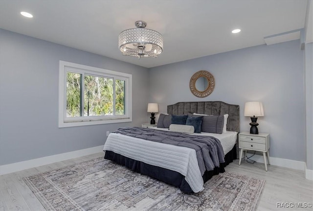 bedroom featuring a notable chandelier and wood-type flooring