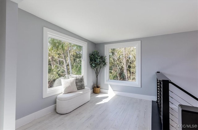 sitting room featuring baseboards and wood finished floors