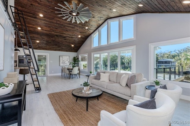 living area with wooden ceiling, high vaulted ceiling, and light wood-style flooring