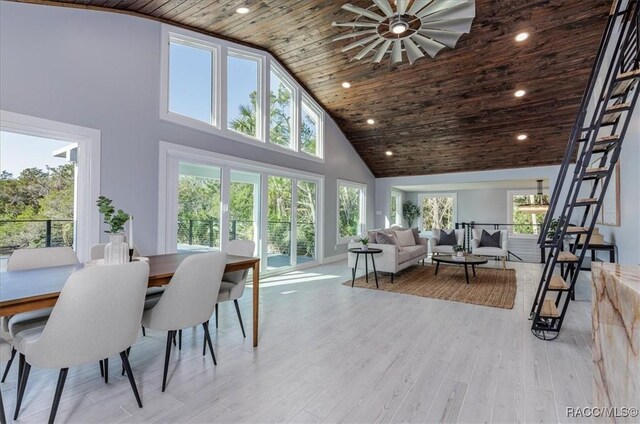 dining area with high vaulted ceiling, wooden ceiling, and light hardwood / wood-style flooring