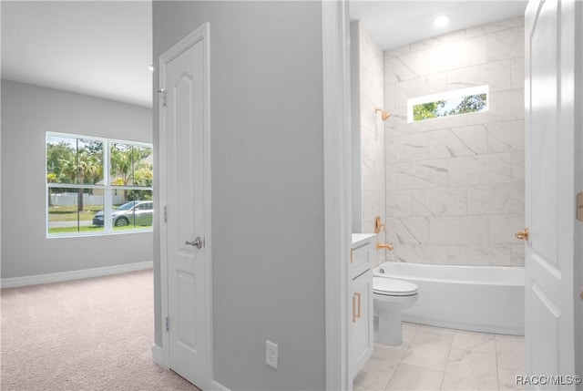 bathroom with vanity, marble finish floor, bathtub / shower combination, and a wealth of natural light
