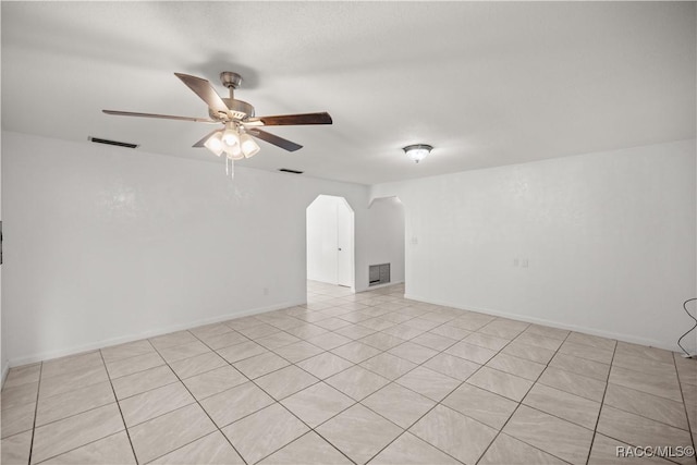 spare room featuring ceiling fan and light tile patterned floors