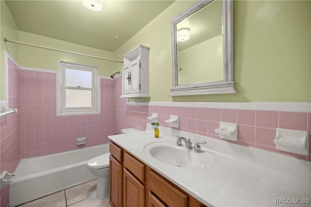 full bathroom with toilet, vanity, tile patterned floors, and tiled shower / bath