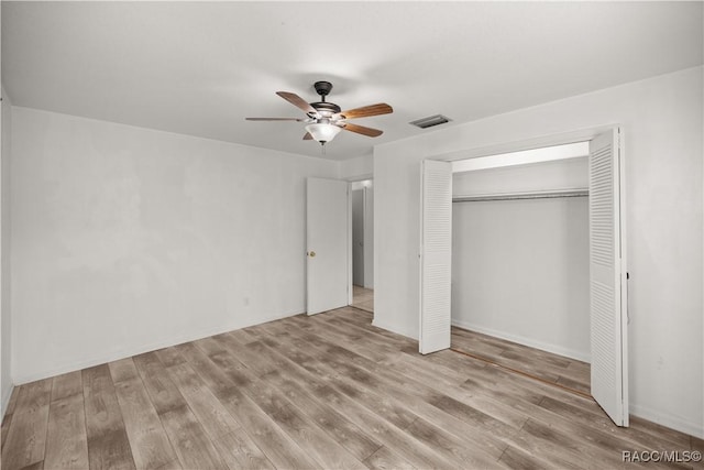 unfurnished bedroom with ceiling fan, light hardwood / wood-style floors, and a closet