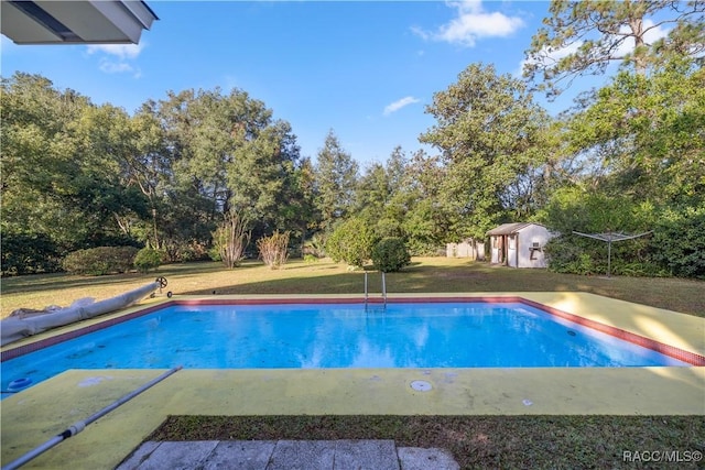 view of swimming pool featuring a yard and a storage unit