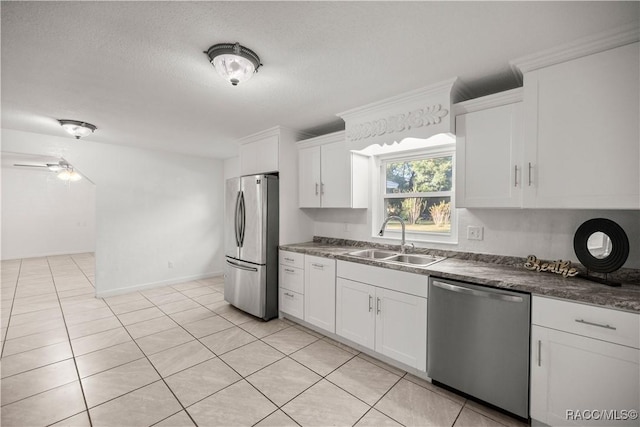 kitchen with sink, white cabinetry, stainless steel appliances, and a textured ceiling