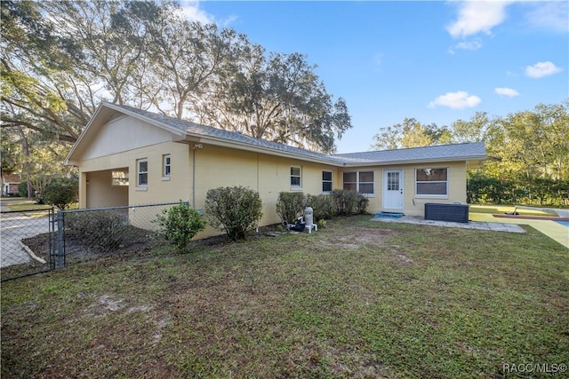 back of property featuring a lawn