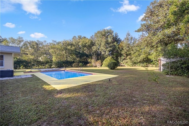 view of pool featuring a lawn