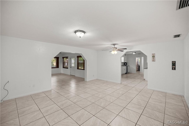 tiled spare room with ceiling fan