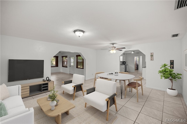 tiled living room featuring ceiling fan