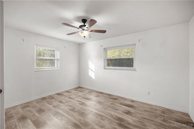 empty room with light wood-type flooring and ceiling fan