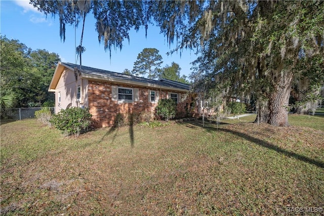 rear view of house featuring a yard