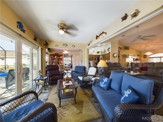 carpeted living room with ceiling fan, plenty of natural light, and vaulted ceiling