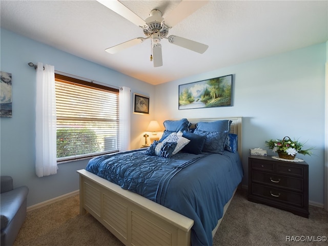 bedroom featuring ceiling fan and dark colored carpet