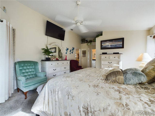 bedroom with ceiling fan, carpet floors, and vaulted ceiling