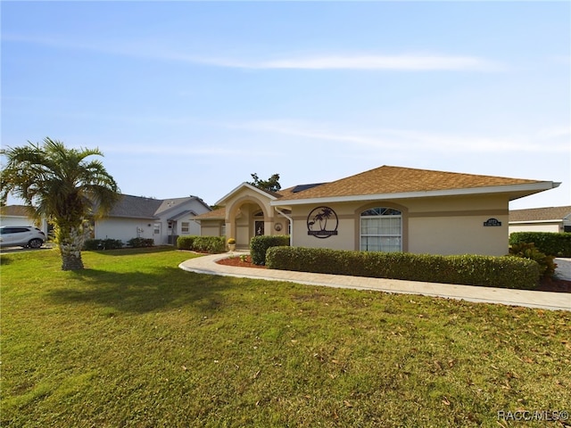 single story home featuring a front lawn